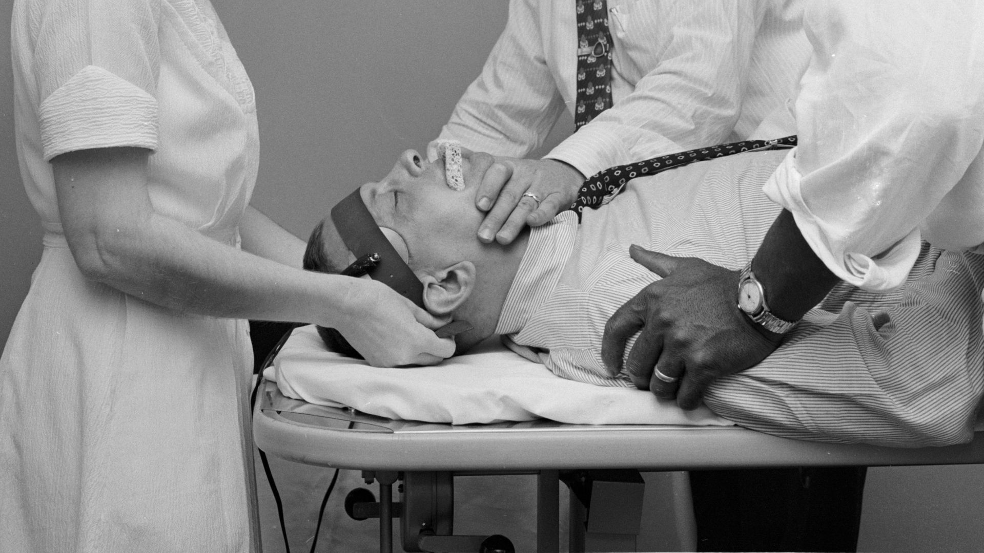In the 1950s, a patient at Hillside mental hospital undergoes electroconvulsive therapy (ECT), which is used to treat severe depression.
