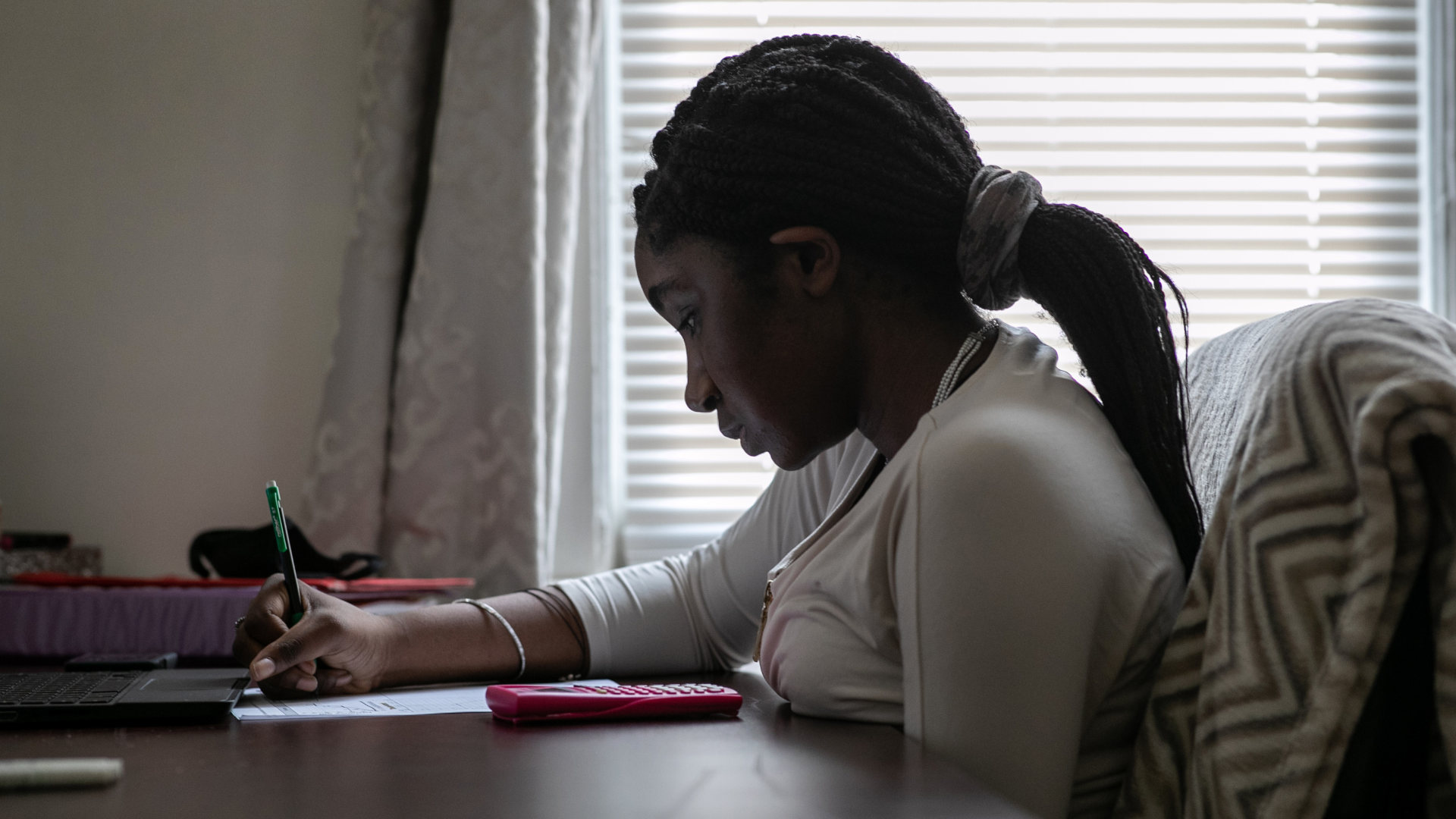 Abigail Previlon, 13, takes part in online learning at home on October 28, 2020 in Stamford, Connecticut. At the time, Stamford Public Schools was using a hybrid educational model due to the Covid-19 pandemic.
