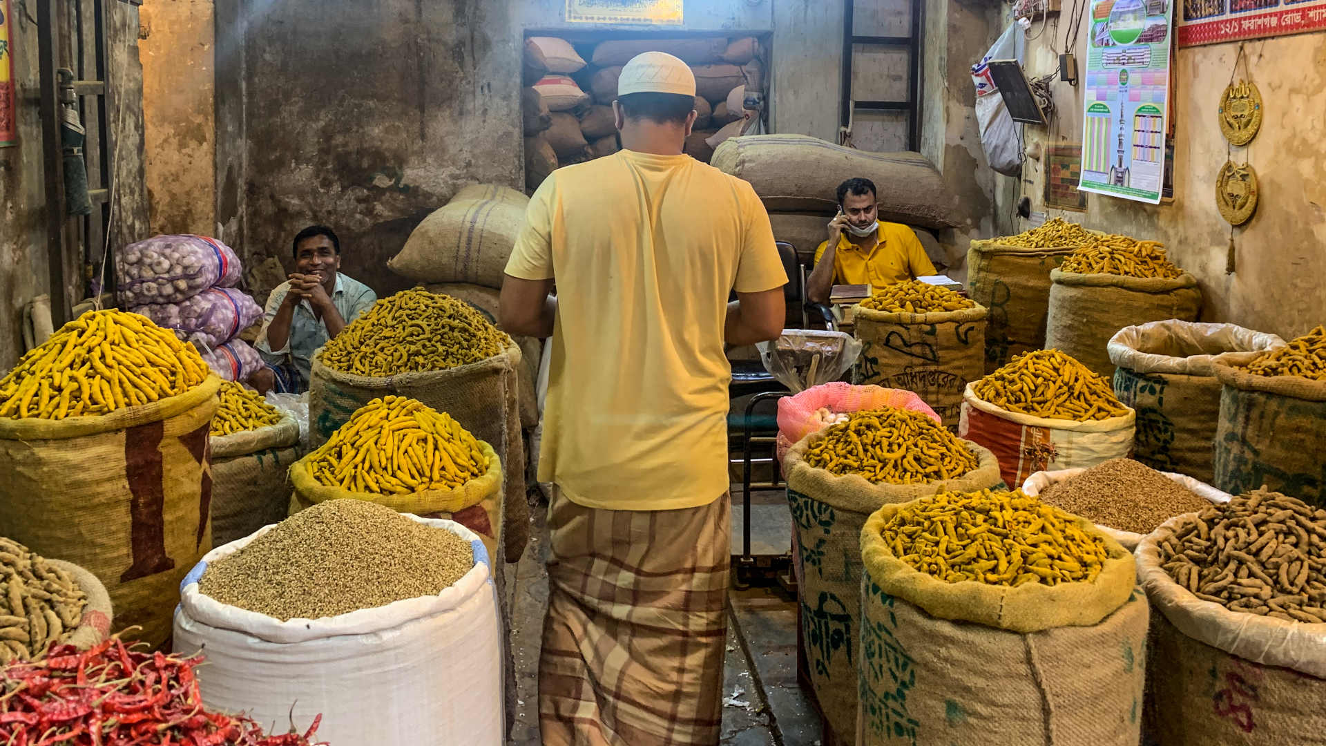 Bright yellow turmeric stands out among other spices that retailers sell at Shyambazar, Bangladesh's largest wholesale spice market.