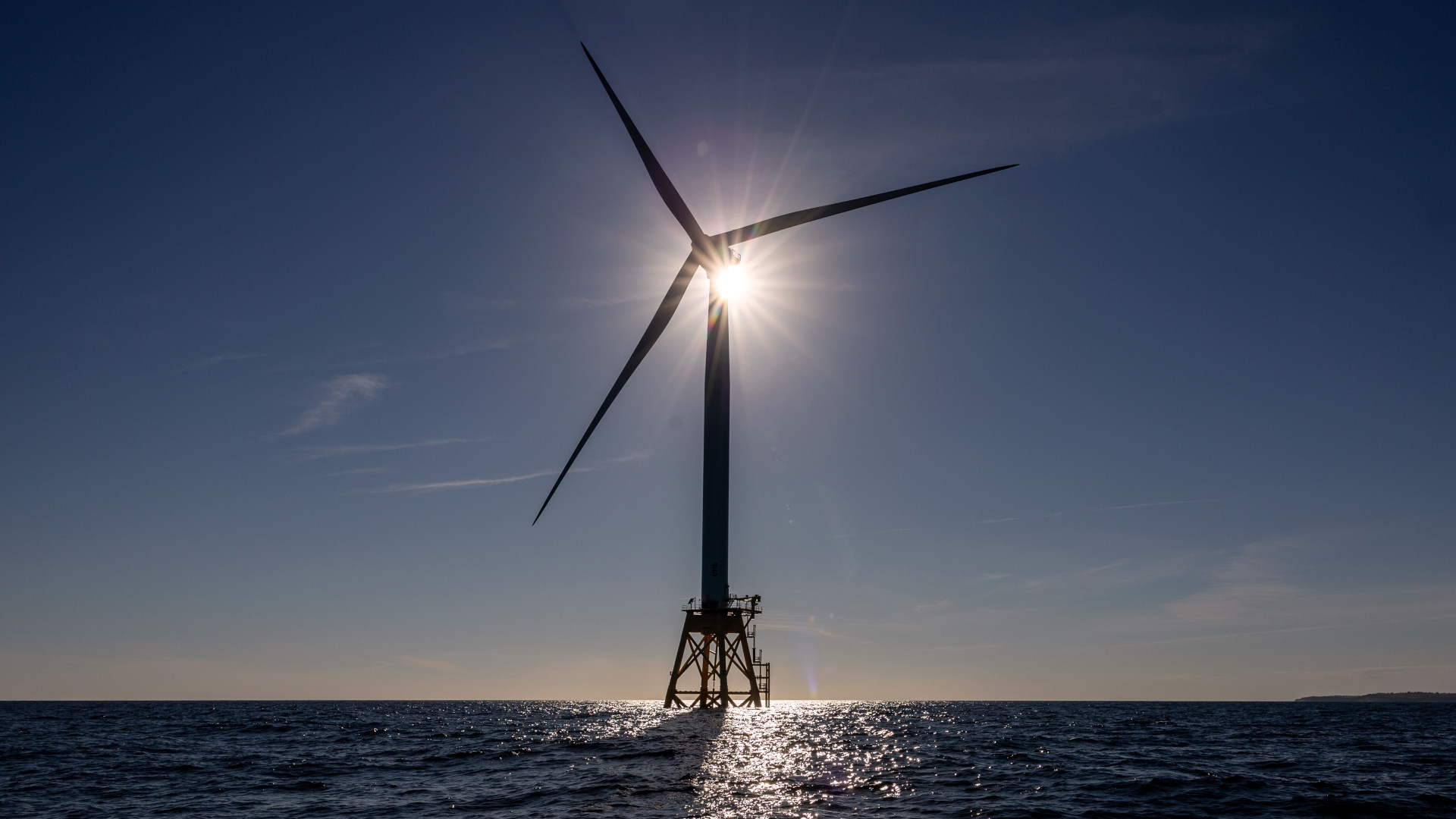 In July 2022, off the coast of Rhode Island, a wind turbine generates electricity at the Block Island Wind Farm, the first commercial offshore wind farm in the United States.