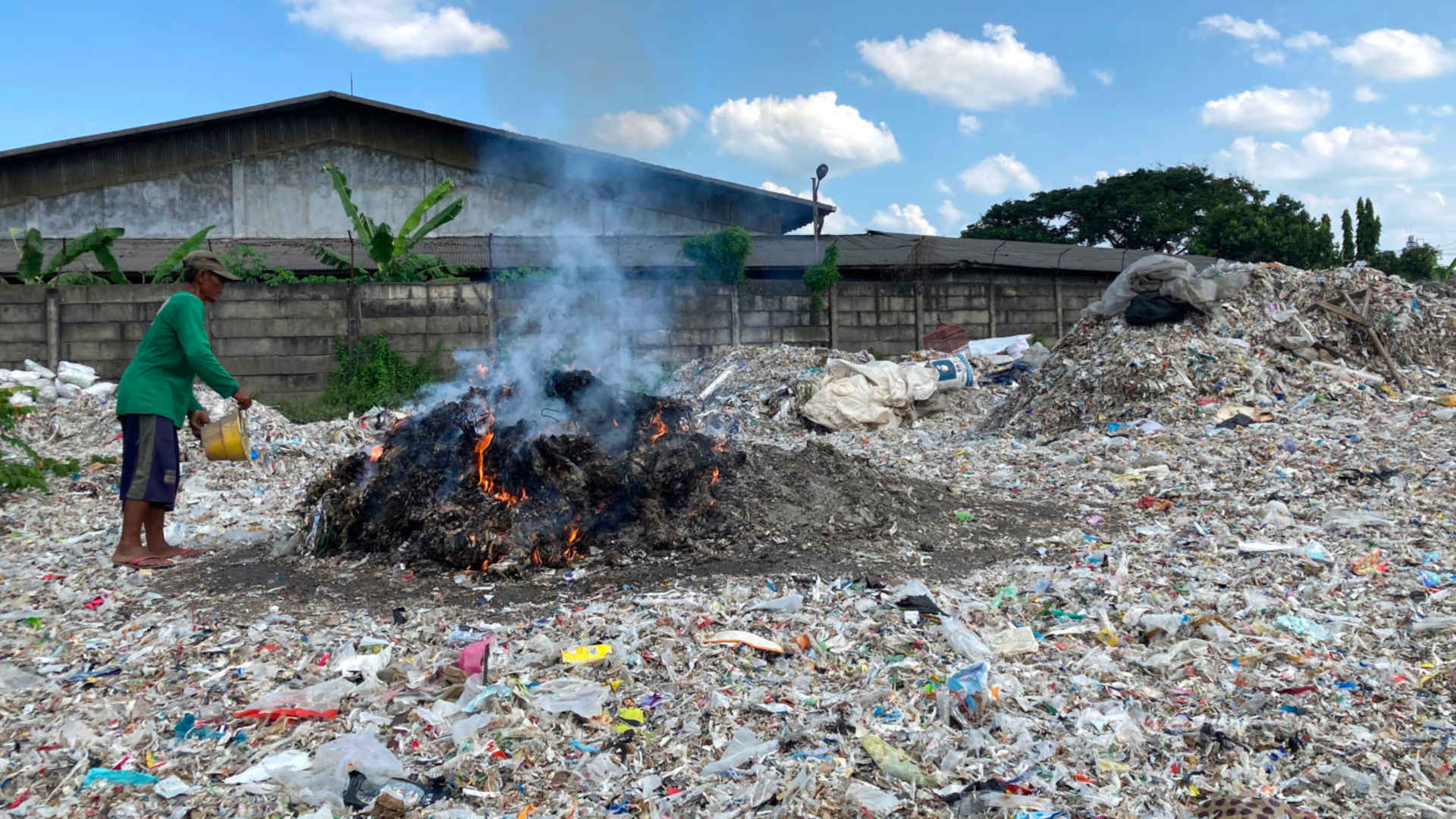 A plastic dump, full of foreign waste, near a paper mill in East Java, Indonesia.