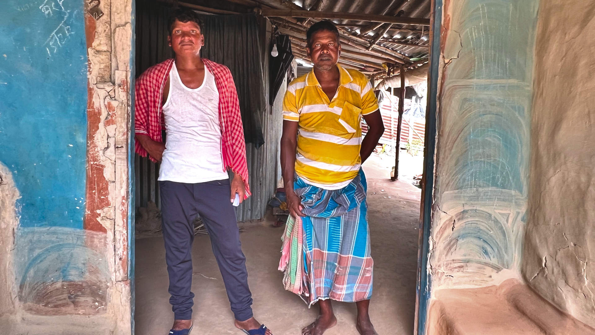 Sanjeet Pahan (left) and his brother (right) at Pahan’s home in a village in West Bengal, India. Pahan has an extreme case of post-kala-azar dermal leishmaniasis.