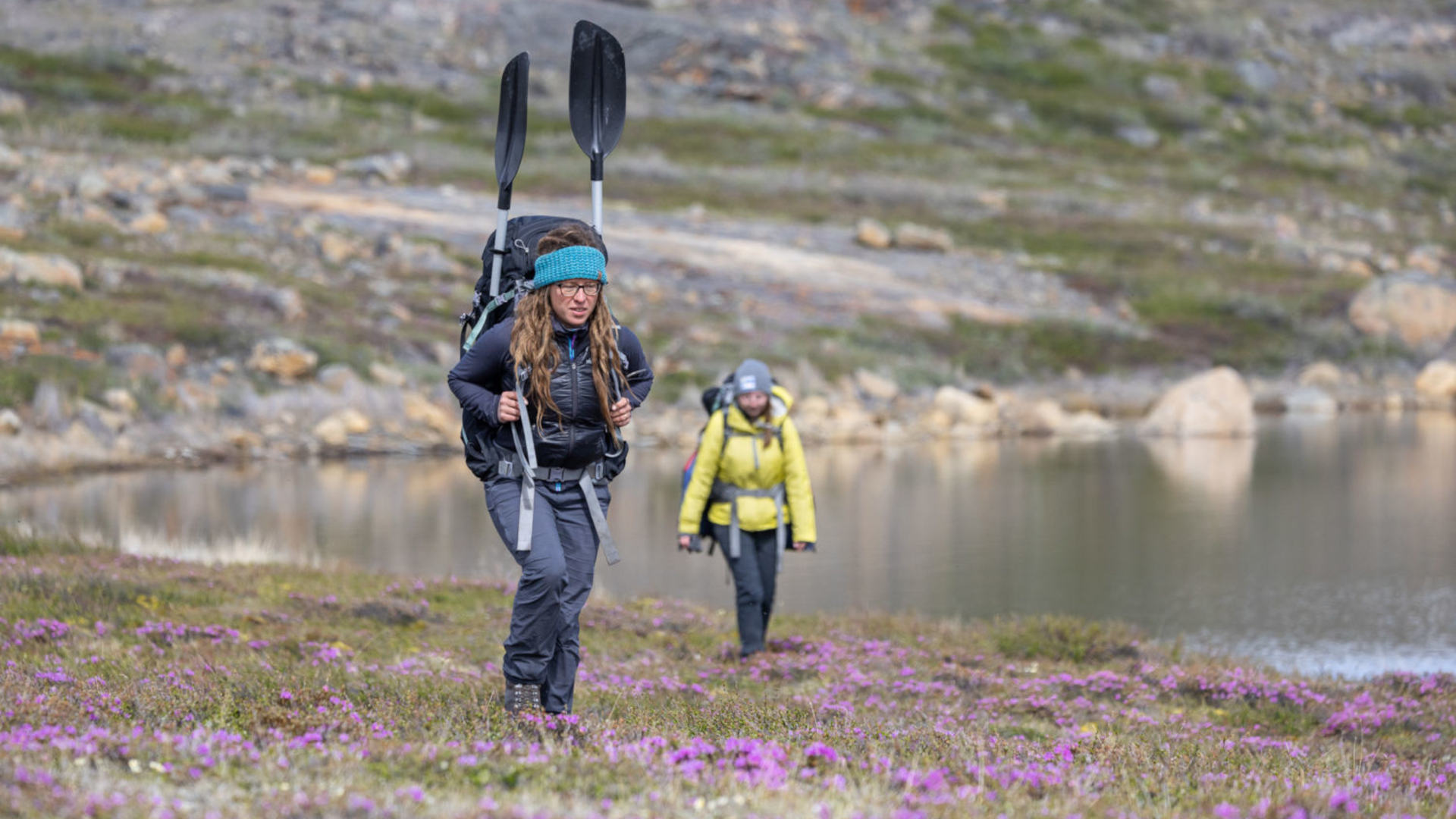 University of Maine researchers Václava Hazuková (front) and Ansley Grider hike over tundra on their way to study lakes in West Greenland.