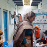 Women wait in line at a cervical cancer screening clinic in Kadipur village, India.