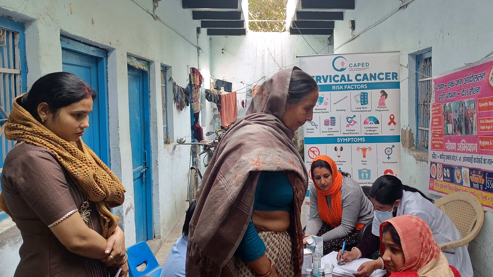 Women wait in line at a cervical cancer screening clinic in Kadipur village, India.