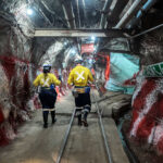Staff members of the mining company Gold Fields walk in tunnels of the South Deep gold mine in Gauteng, South Africa in October 2022.