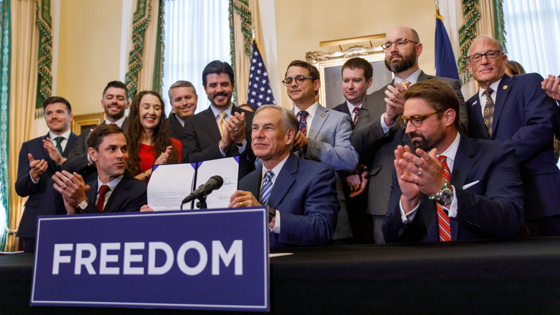 Gov. Greg Abbott signs a bill which bans Covid-19 vaccine requirements for all private businesses at the Governor's Mansion in Austin on Nov. 10, 2023.