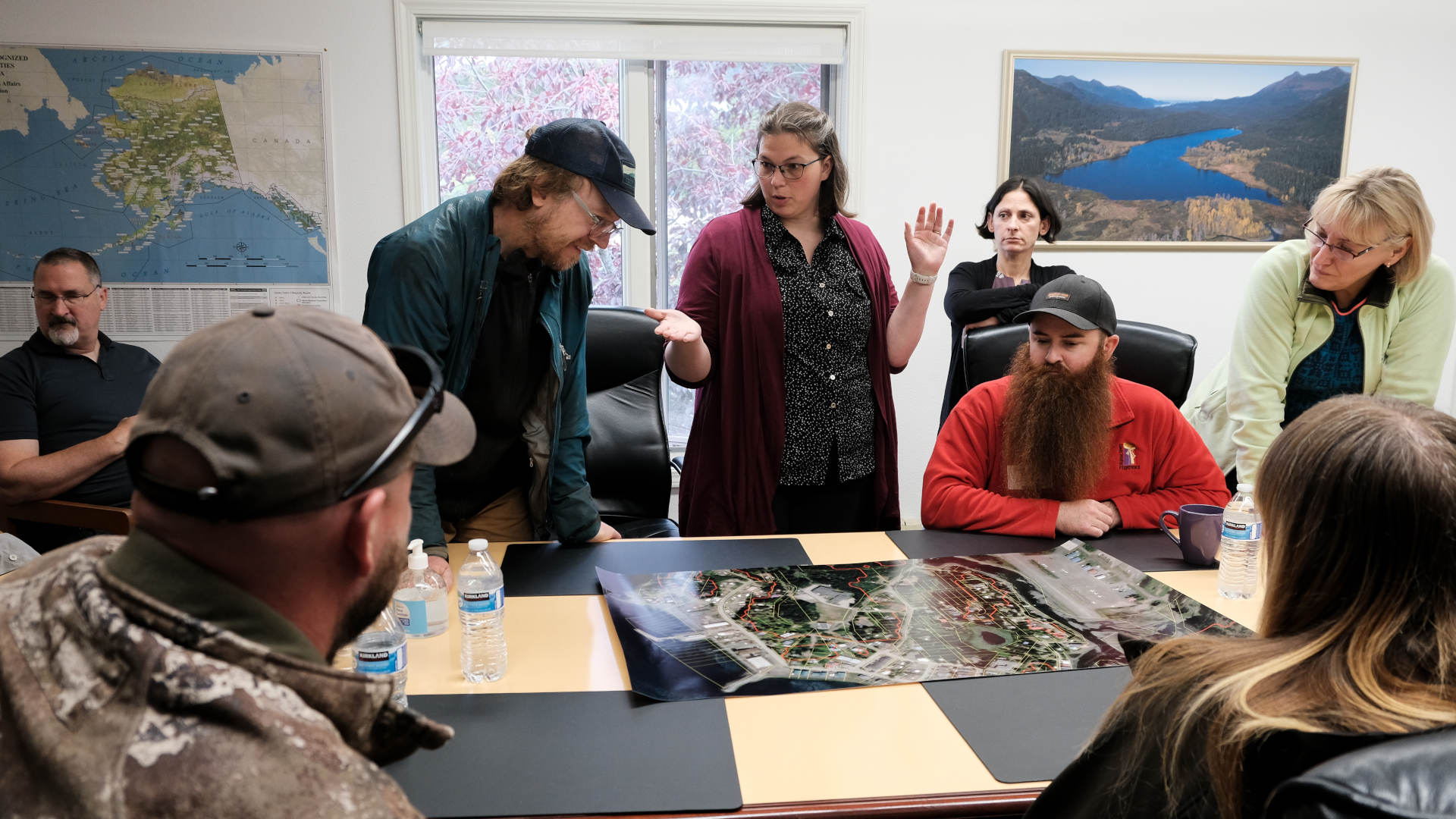 In Seldovia, Alaska, city manager Heidi Geagel (center) discusses the town's tsunami evacuation zone with local geologist Bretwood Higman (left), tsunami scientists Barry Salisbury (right) and Elena Suleimani (far right), and community members.