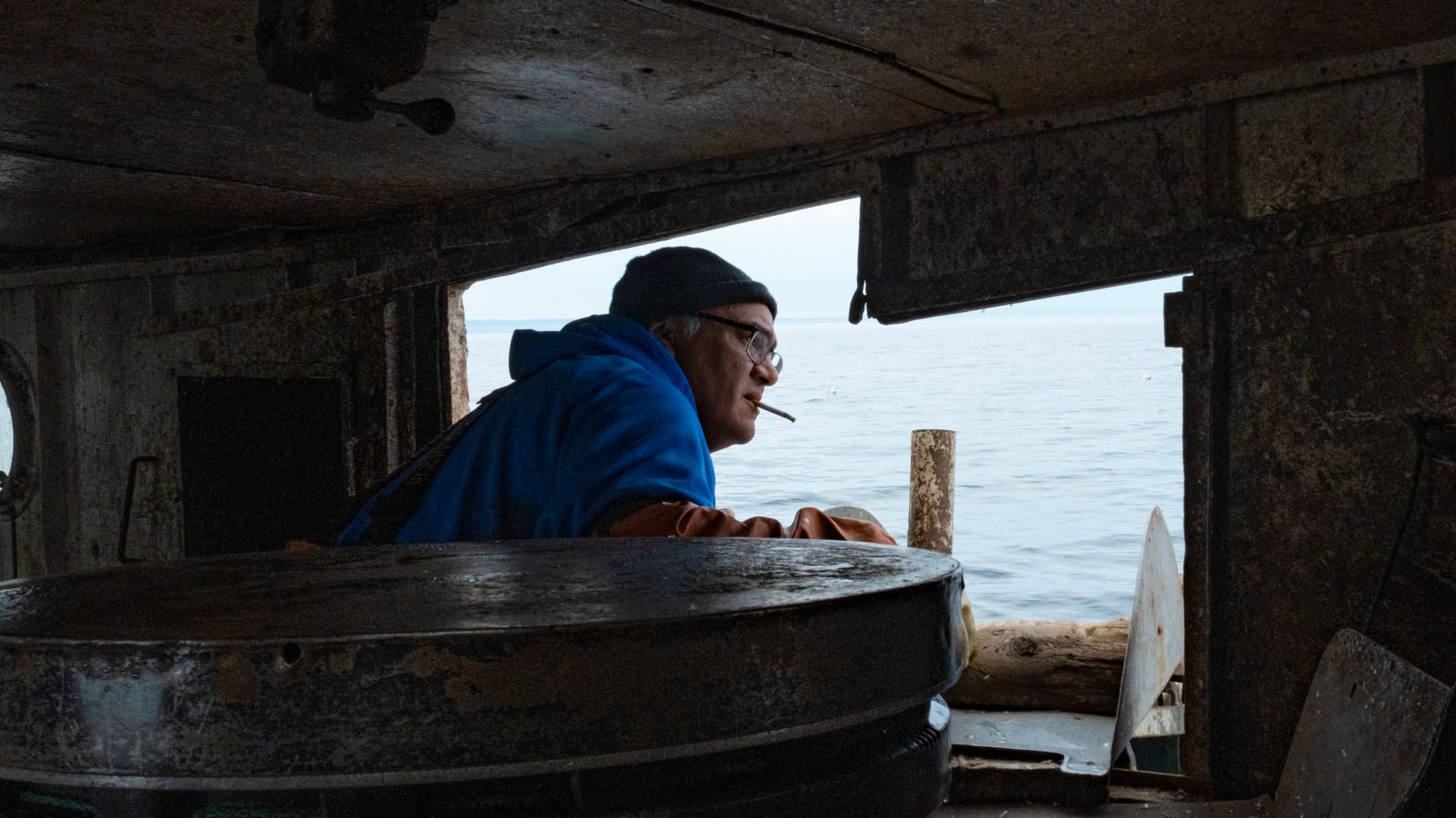 Captain Chris Peterson stands aboard the Three Suns fishing tug, peering out onto the waters of Lake Superior. Peterson and his deckhand Richard Bruneau fish on the west side of the Keweenaw Peninsula, in a remote part of Michigan’s Upper Peninsula.