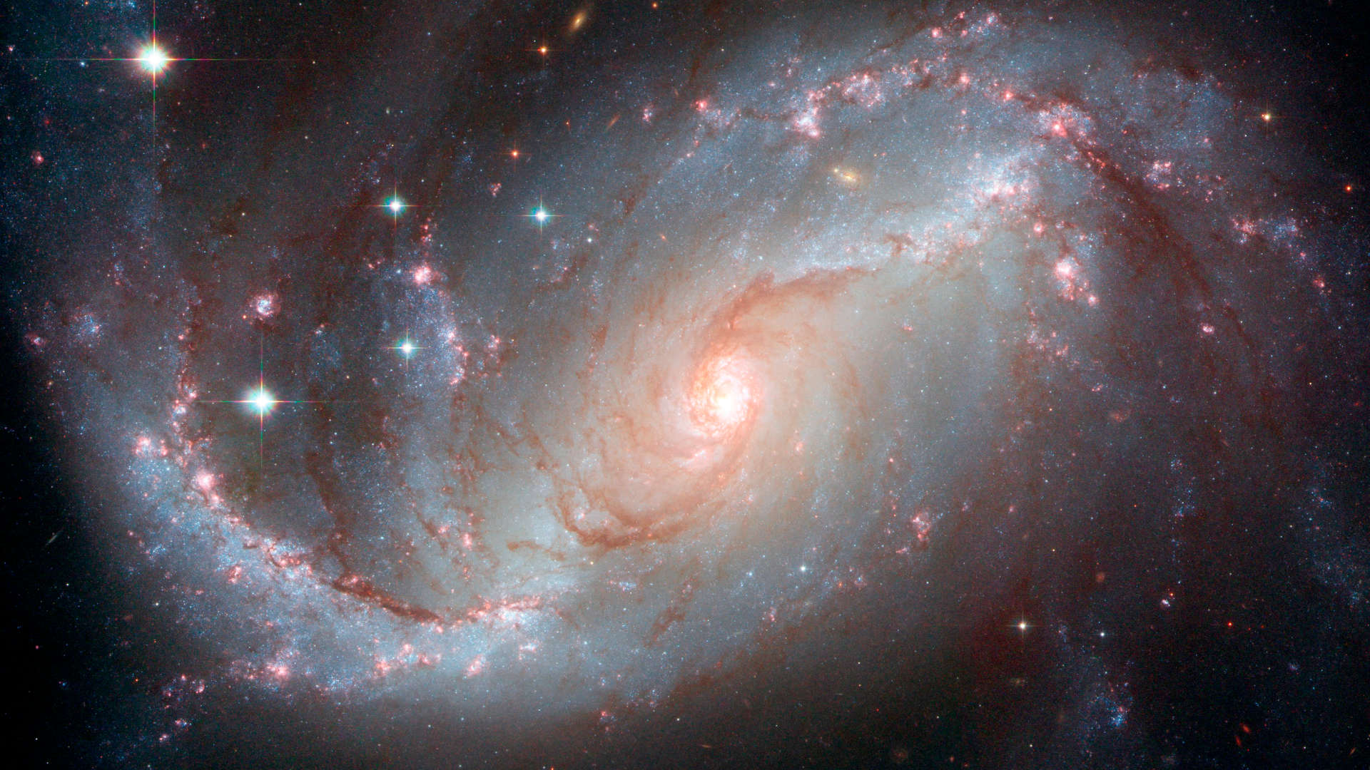 A Hubble Space Telescope image of the barred spiral galaxy known as NGC 1672, which is likely powered by a supermassive black hole at its center.