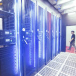 A worker looks at a server used for cloud computing at the Hanggang Cloud Computing Data center in Hangzhou, China.