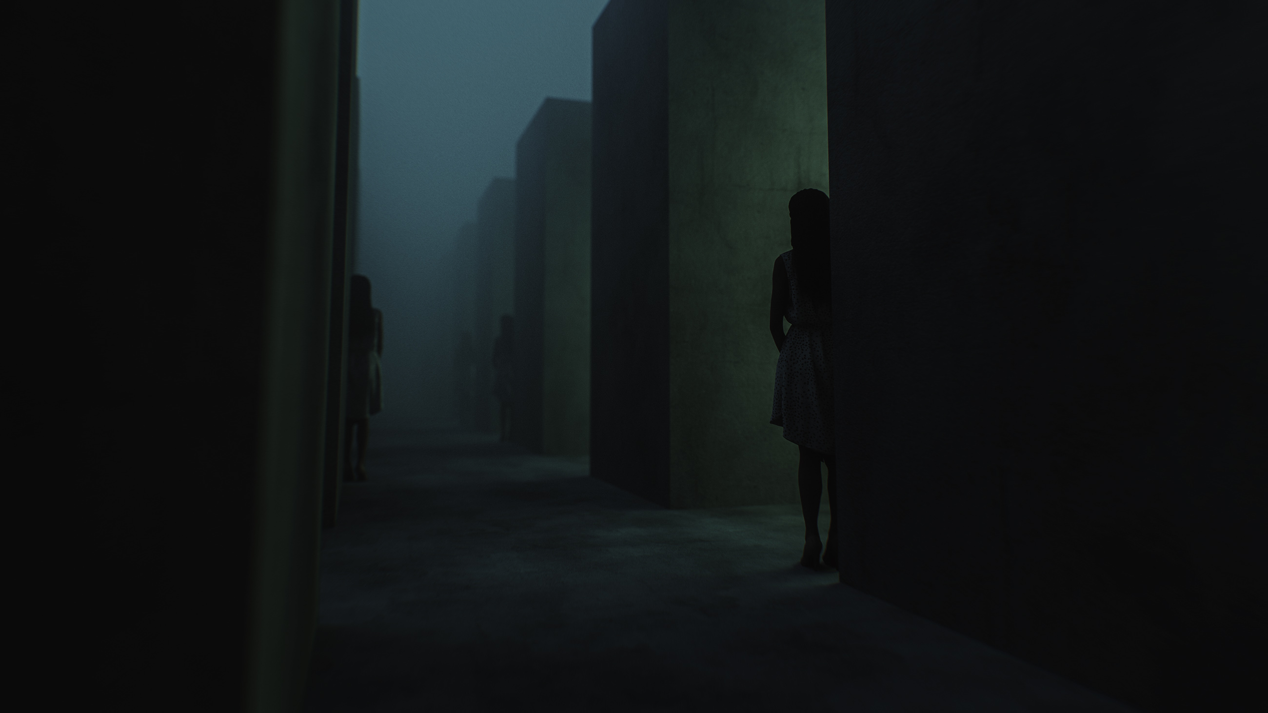 Women standing in dark concrete maze.
