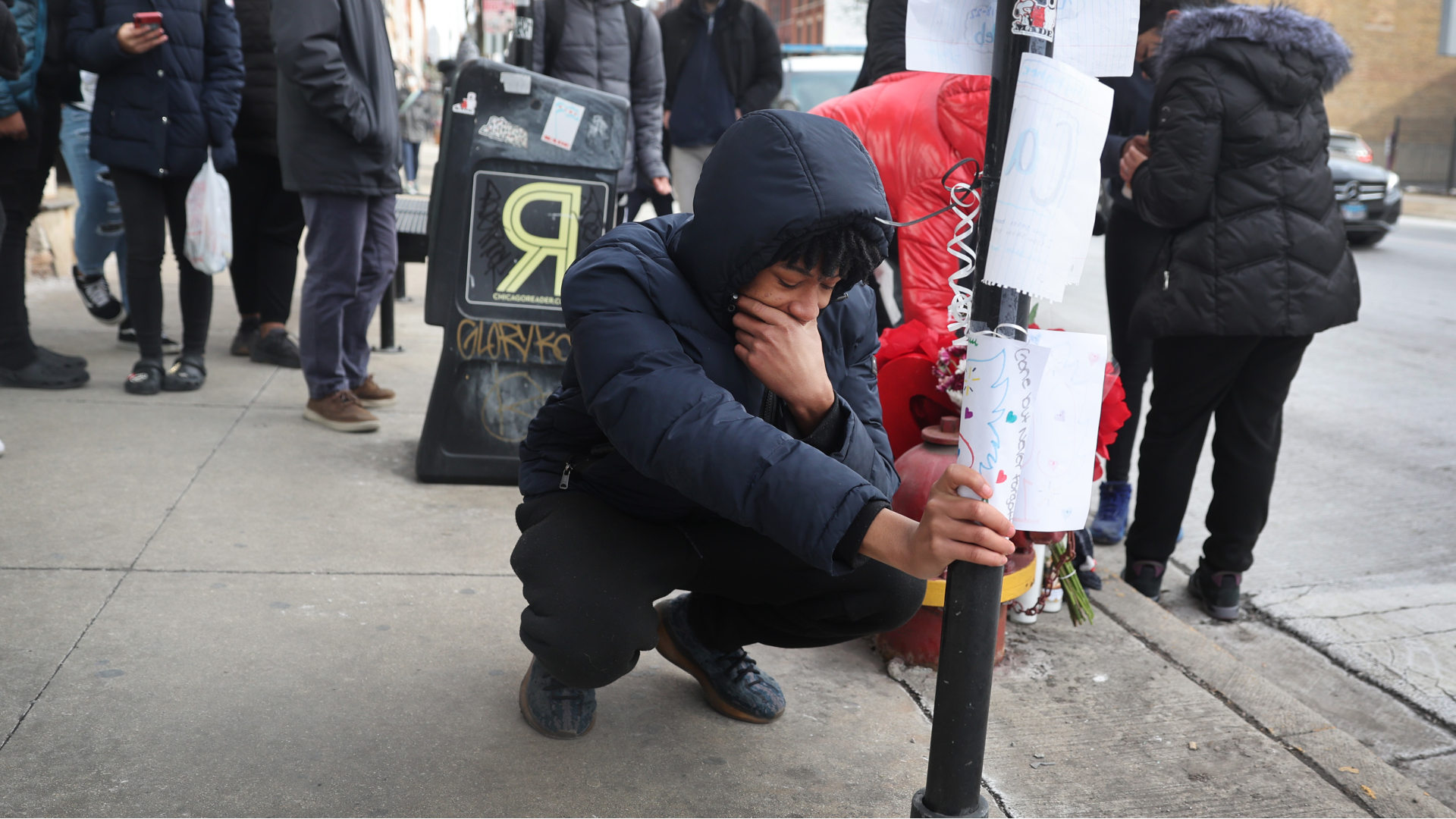 In Chicago, friends and classmates visit a memorial for 15-year-old Caleb Westbrooks, who was shot and killed nearby on January 18, 2022. He was one of 5 children shot in the city that afternoon.