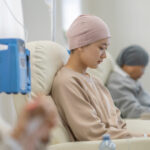 Three women sit in individual chairs as they receive their Chemotherapy by intravenous.