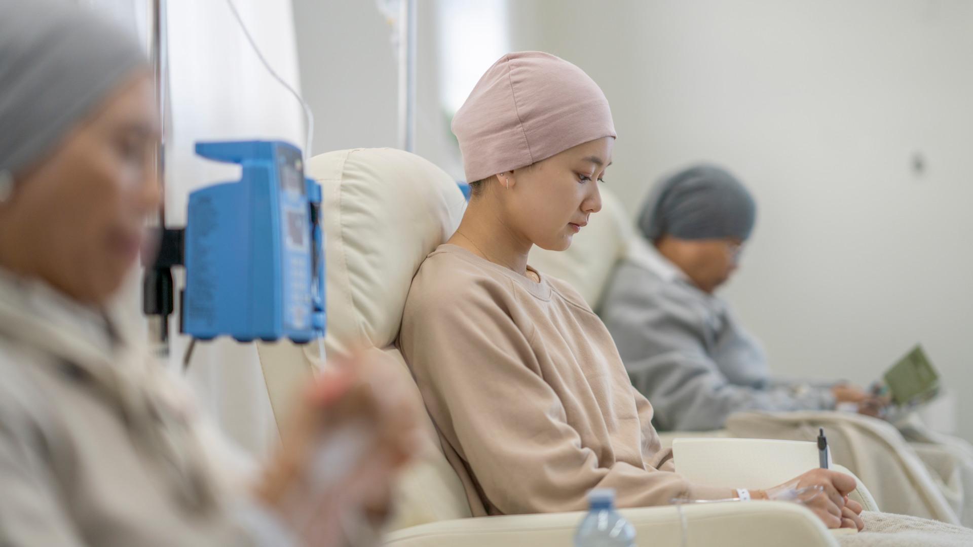 Three women sit in individual chairs as they receive their Chemotherapy by intravenous.