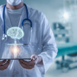 Doctor holding tablet showing human brain and body
