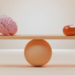 Conceptual image of an orange seesaw with a pink brain and an oversized pill balancing on it, could illustrate ideas around ssri, anti-depressants, headache pills and other medication for mental and brain health