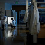 Female scientist looking in refrigerator in research lab