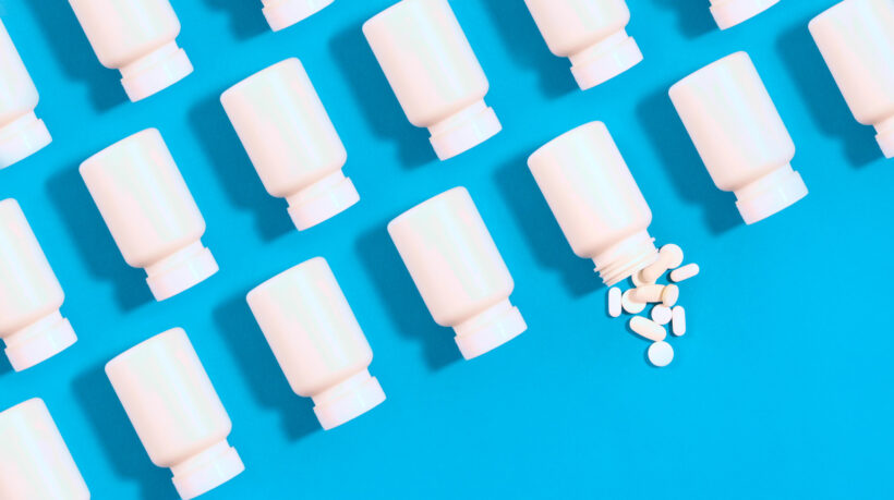 White pill bottles on blue background