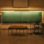 a green chalkboard in a college classroom