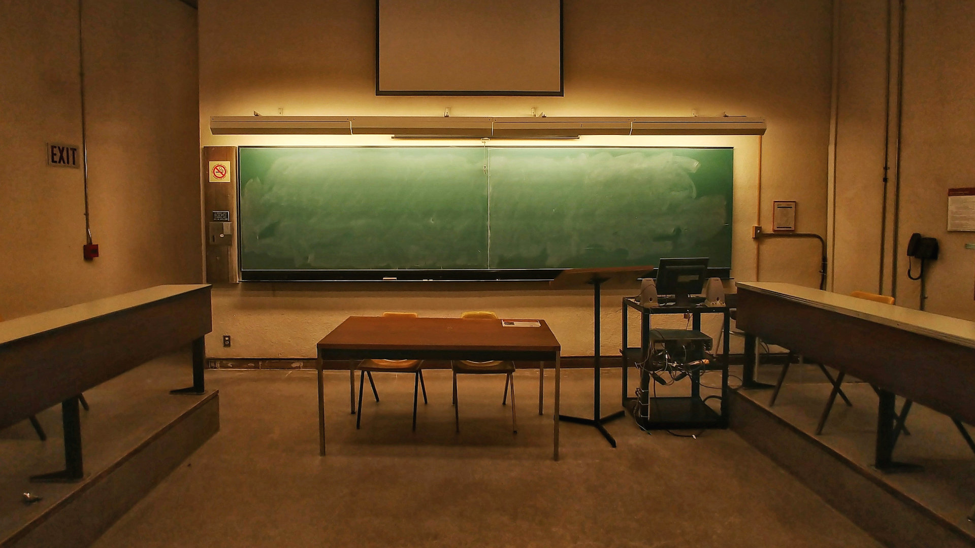 a green chalkboard in a college classroom
