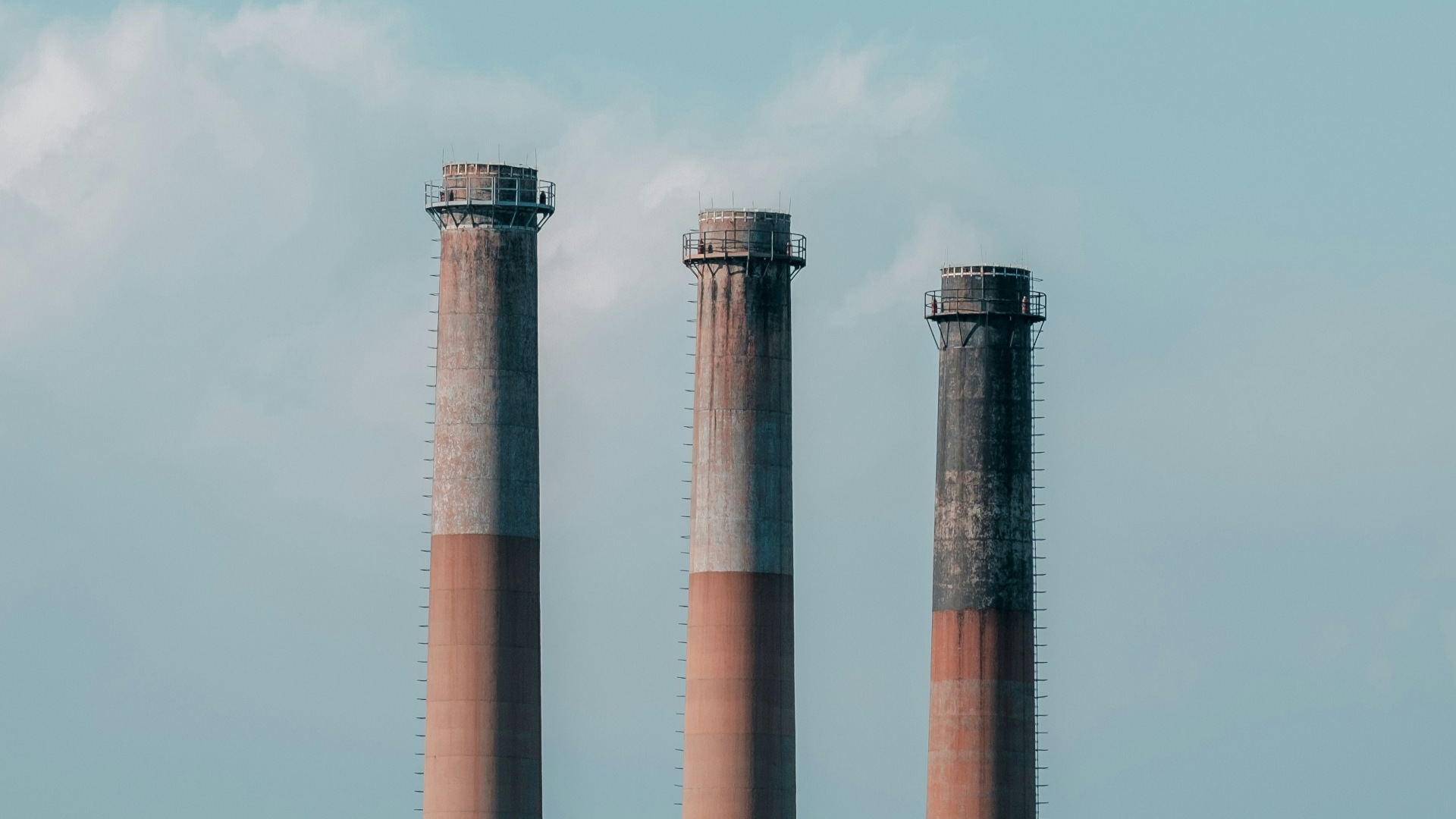 three smokestacks at a power generation station