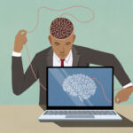 Businessman at laptop pulling at string in brain