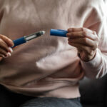 Semaglutide injection pen in hands, ready for preparation. This modern injectable device is used for weight management and diabetes treatment, representing advancements in healthcare solutions.