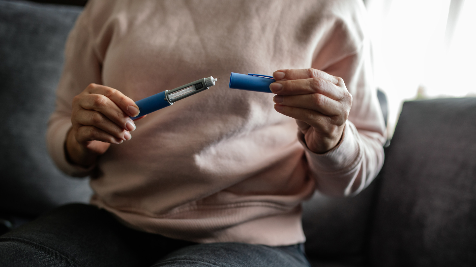 Semaglutide injection pen in hands, ready for preparation. This modern injectable device is used for weight management and diabetes treatment, representing advancements in healthcare solutions.