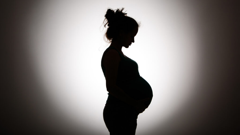 Silhouette of pregnant woman in black and white