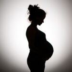 Silhouette of pregnant woman in black and white