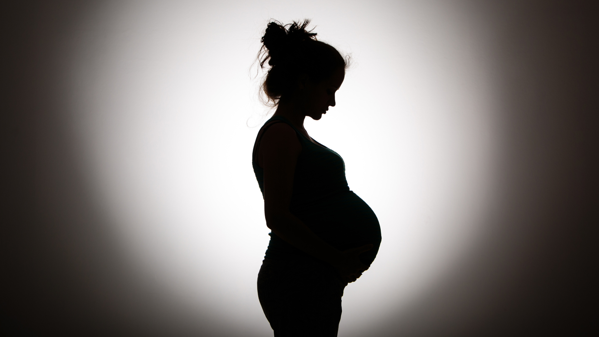 Silhouette of pregnant woman in black and white