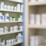 Medications are stored on shelves at a pharmacy