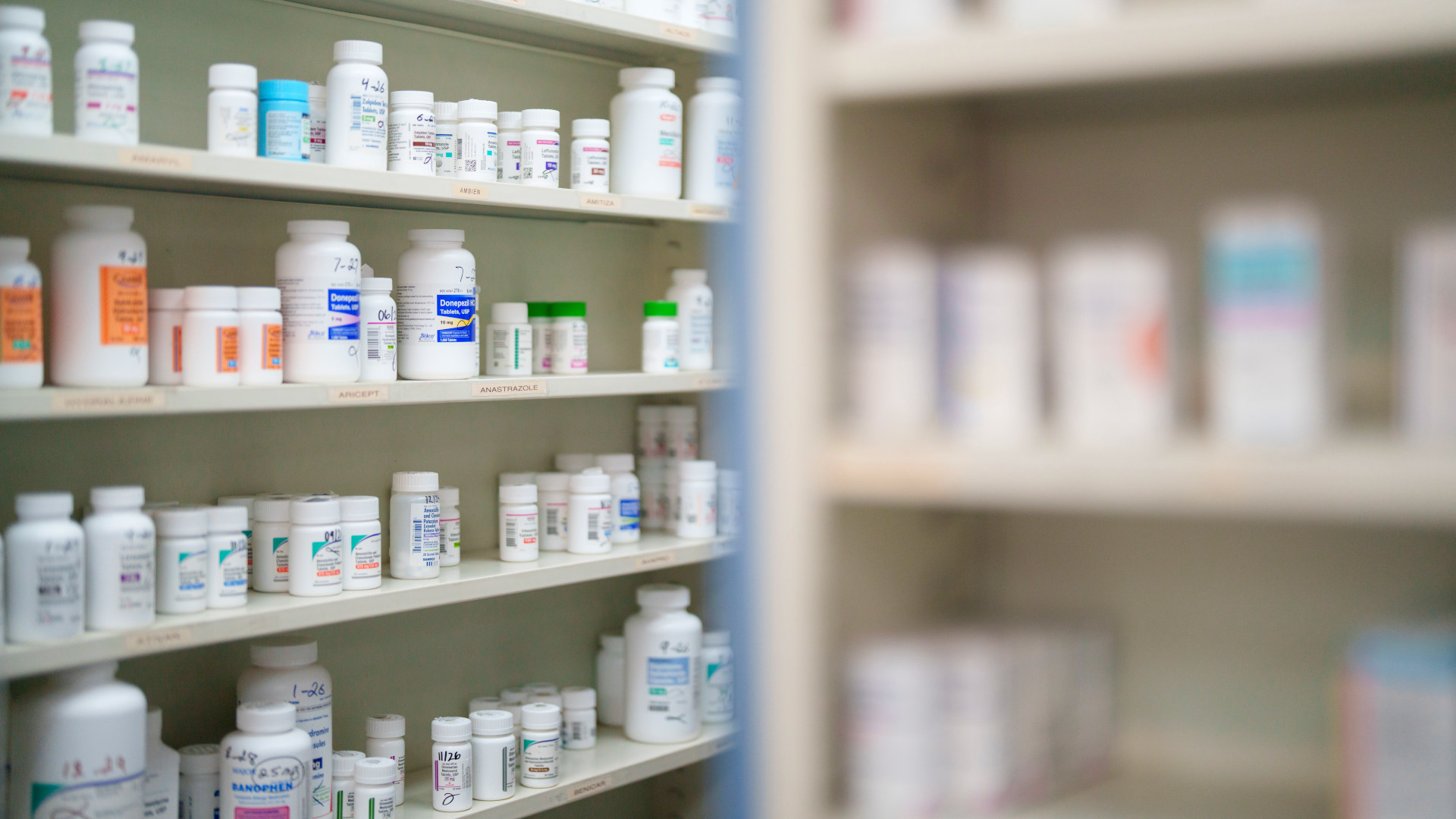 Medications are stored on shelves at a pharmacy