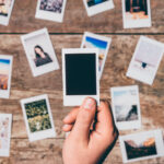 Instant camera prints on a table. Top view.