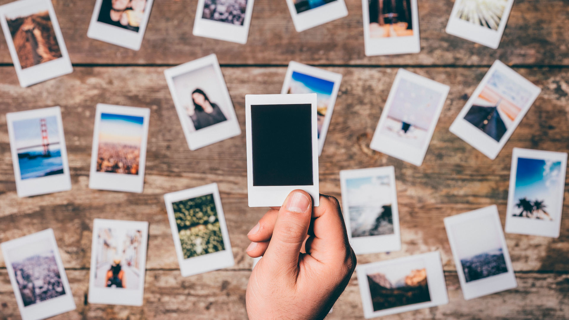 Instant camera prints on a table. Top view.