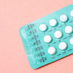 birth control pills on a pink background