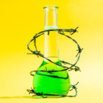 Barbed wire around a Beaker on yellow background.