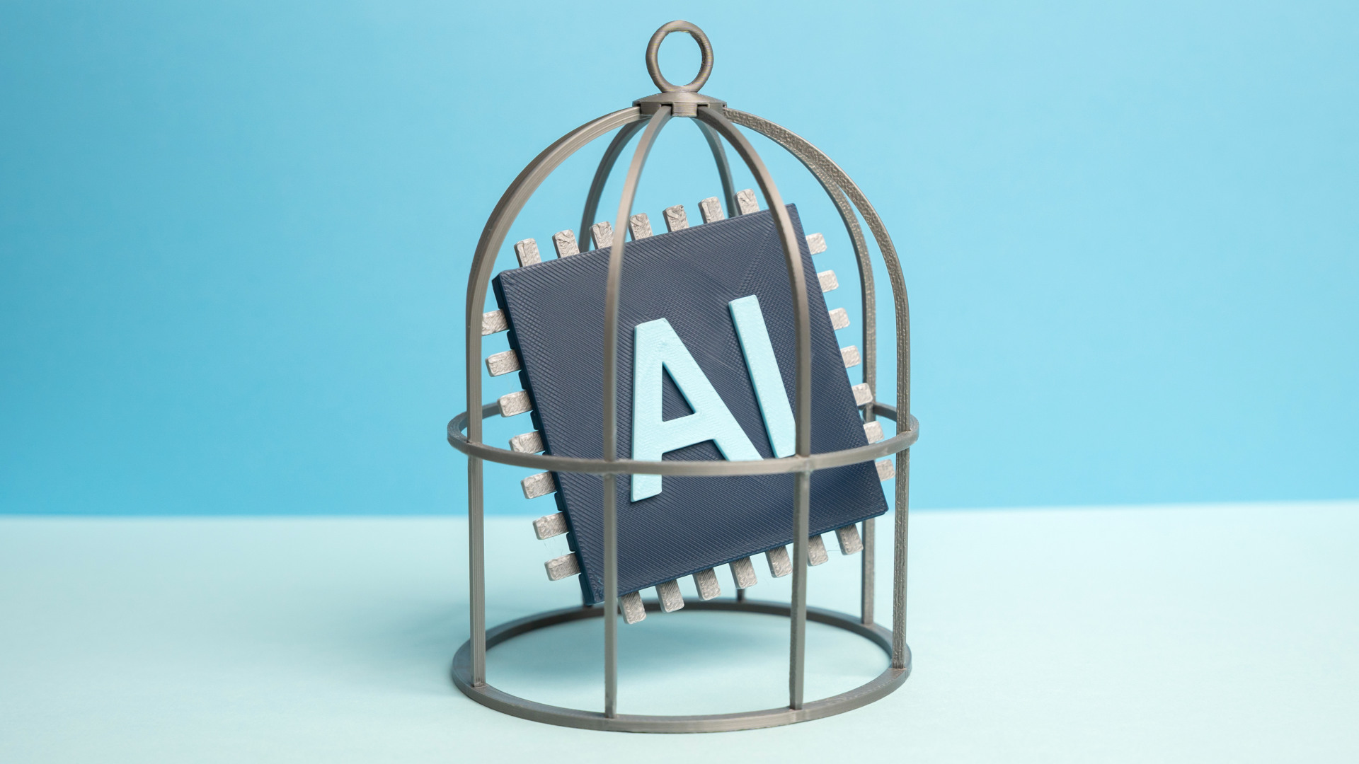 An AI computer chip locked in a birdcage.