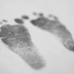 Baby footprints inked on paper