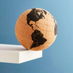 A globe sits on the edge of a table, centered on The Americas