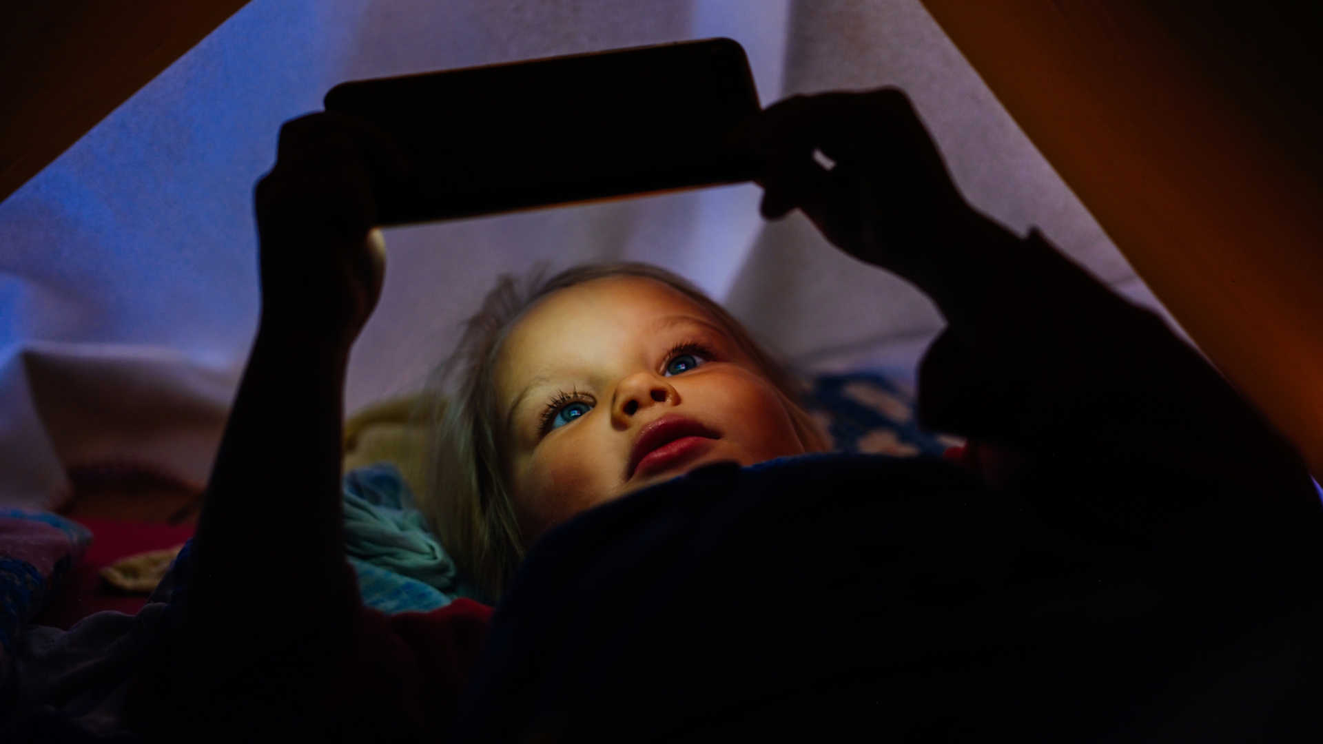 Young girl using mobile phone for watching a short movie.