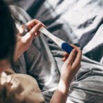 Rear View Cropped Shot Of Unrecognizable Woman Taking Pregnancy Test At Home