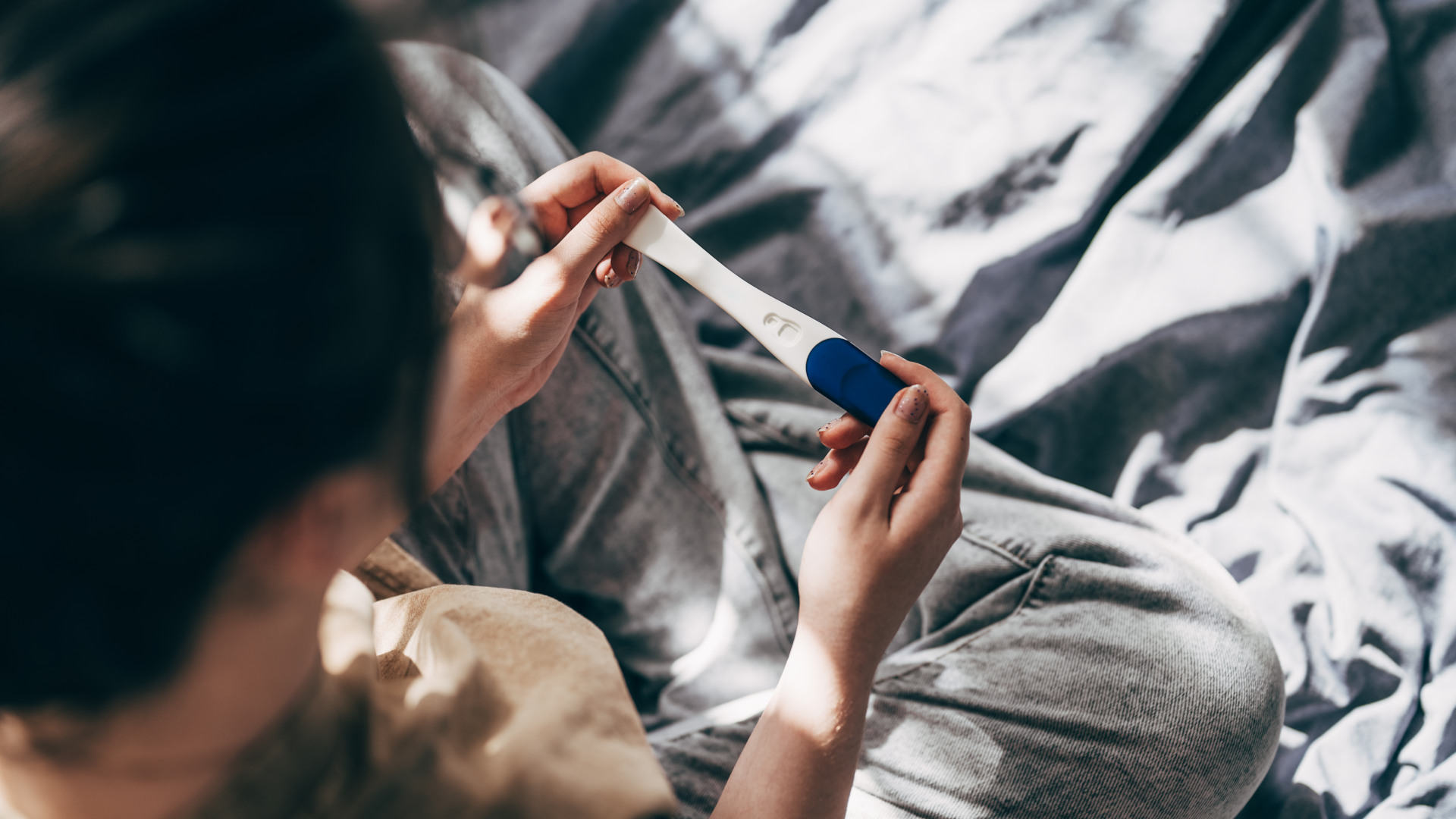 Rear View Cropped Shot Of Unrecognizable Woman Taking Pregnancy Test At Home