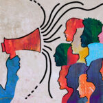 Man speaking holding megaphone and his audience listening