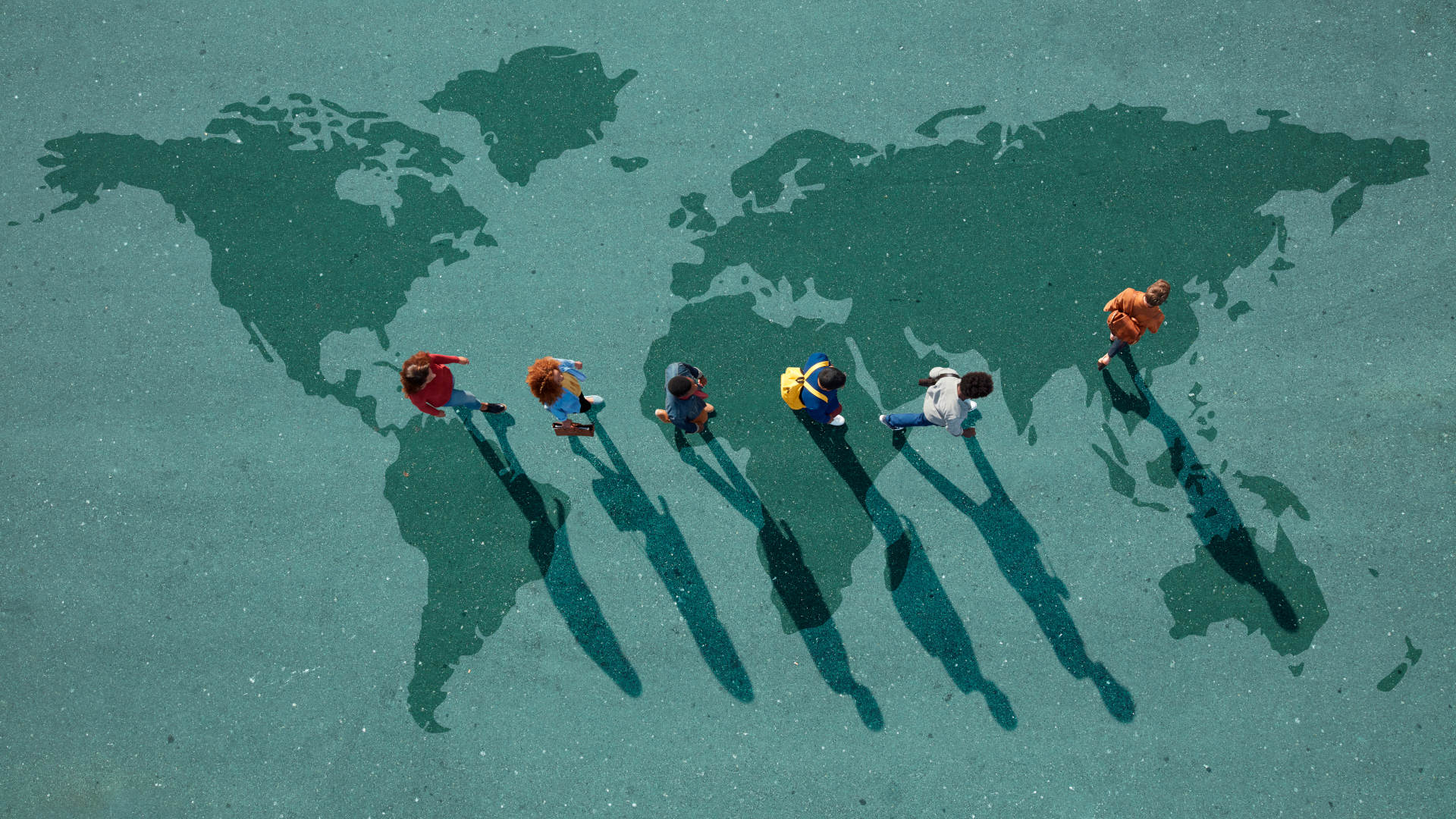 Group of young adults, photographed from above, on various painted tarmac surface, at sunrise.