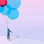 Girl flying with blue and red circle balloons against colored background